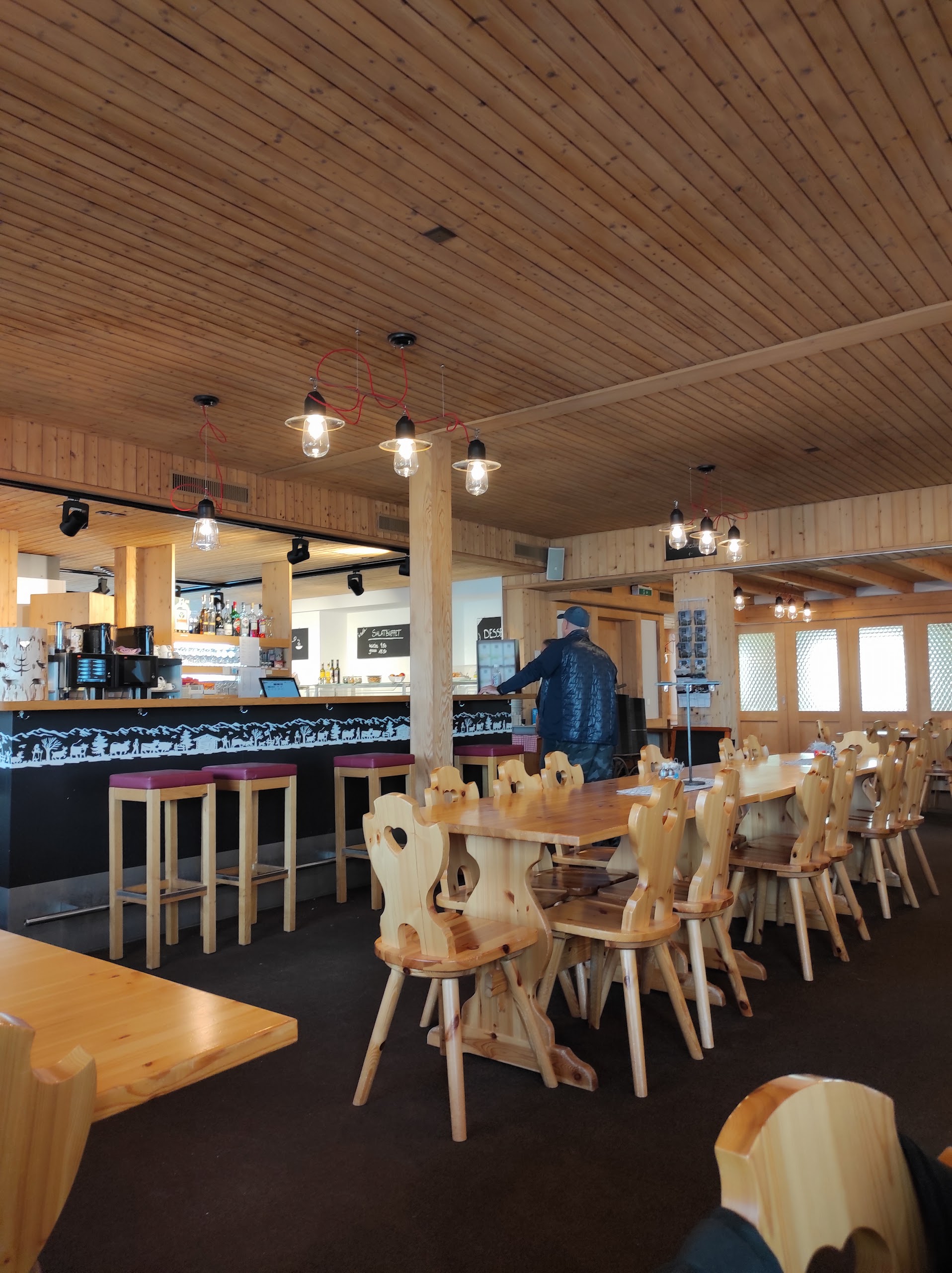 Mountain restaurant terrace above Gstaad with snowy peaks